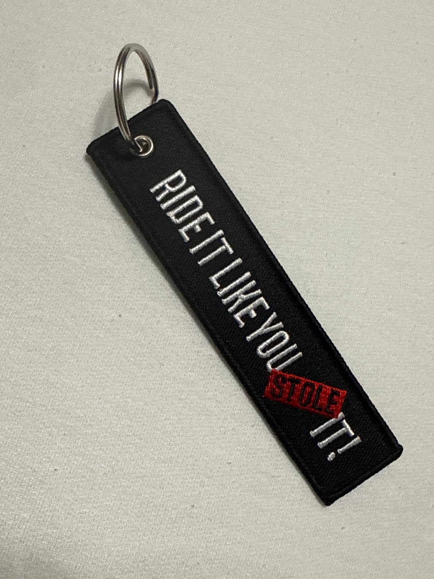 Ride it like you stole it keychain